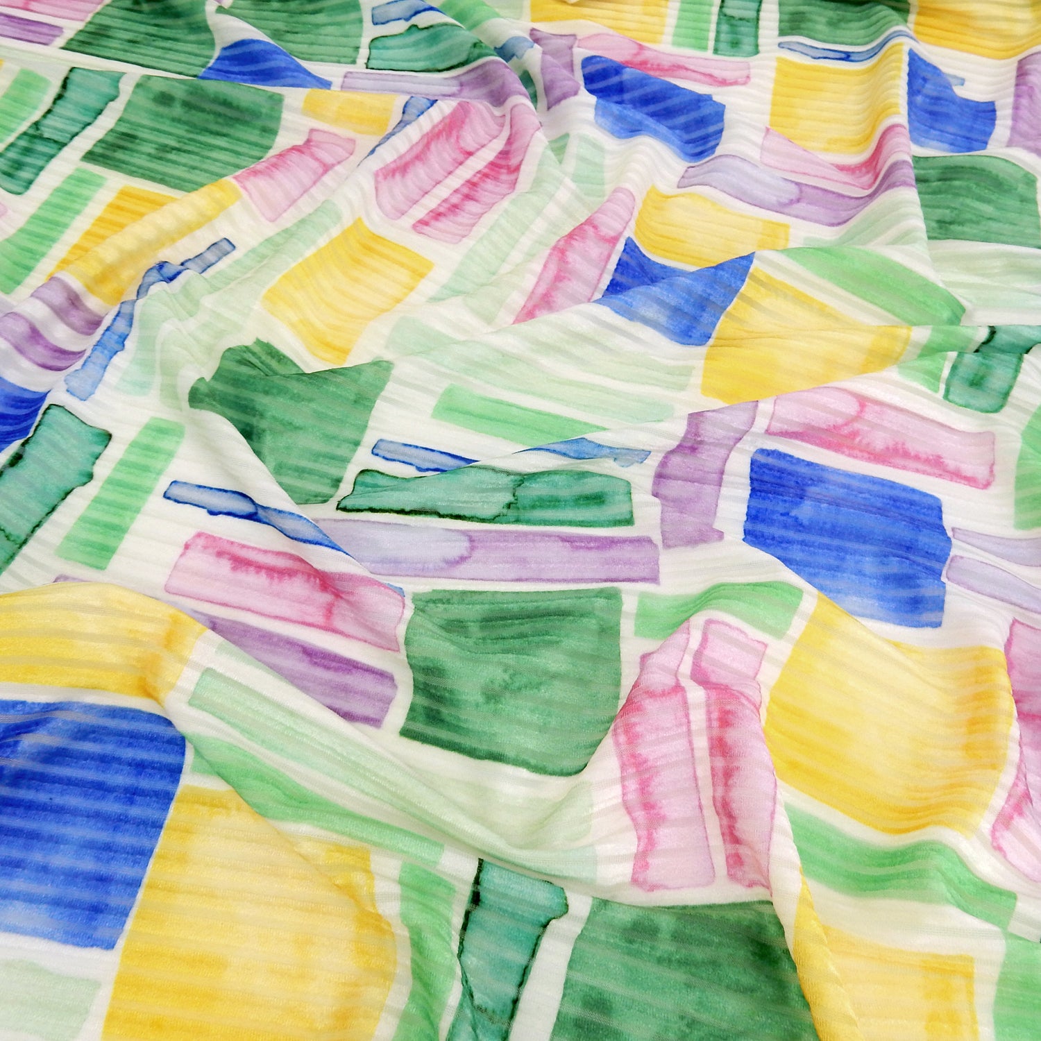 Premium Spanish Geometric Burnout Stretch Velvet fabric. Pastel Multi-Color & Ivory rectangle & square design on 4-way stretch burnout velvet. shown lightly gathered