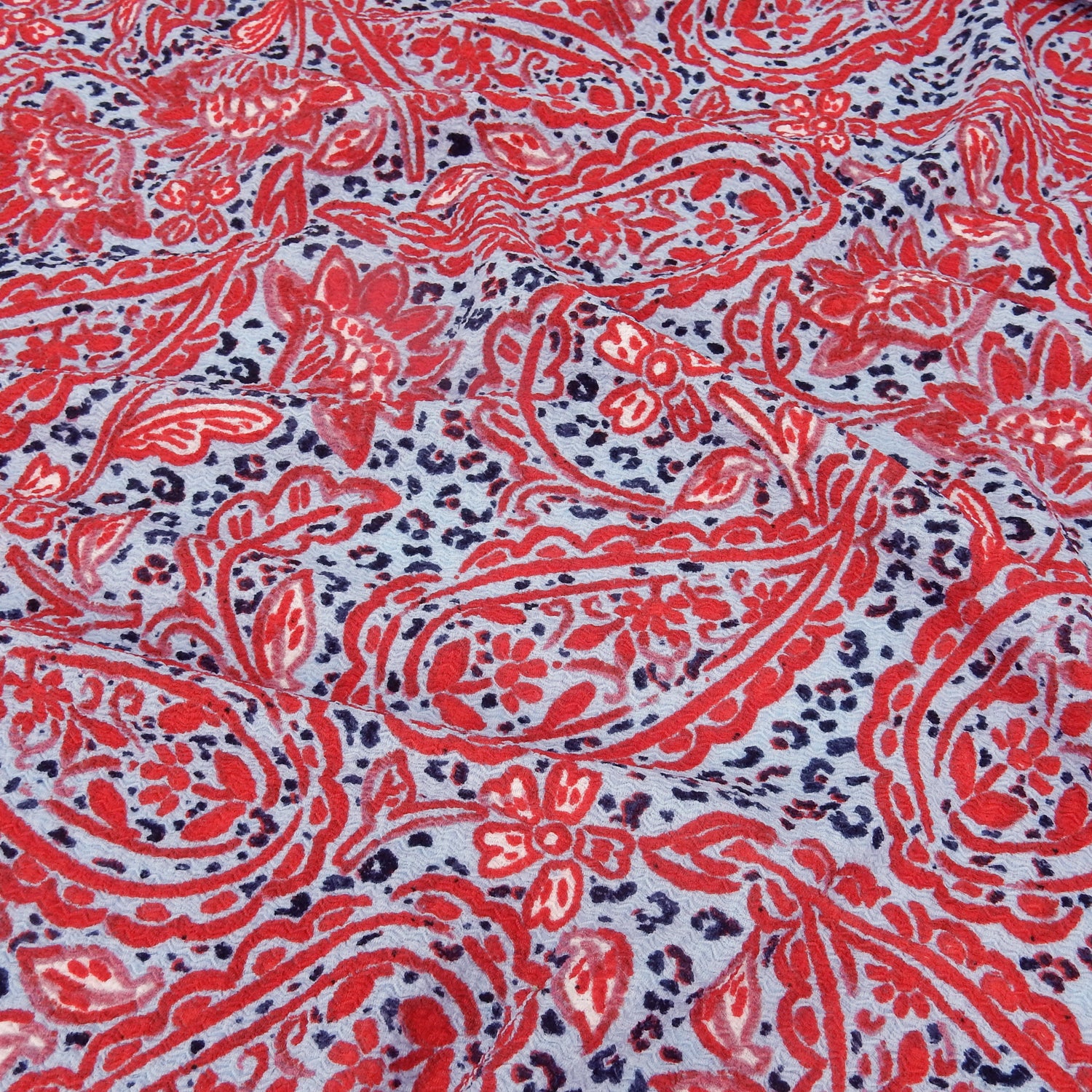 Premium textured stretch jacquard dress fabric. Luxury lightweight polyester spandex blend. Red & sky blue paisley design. shown slighly gathered up