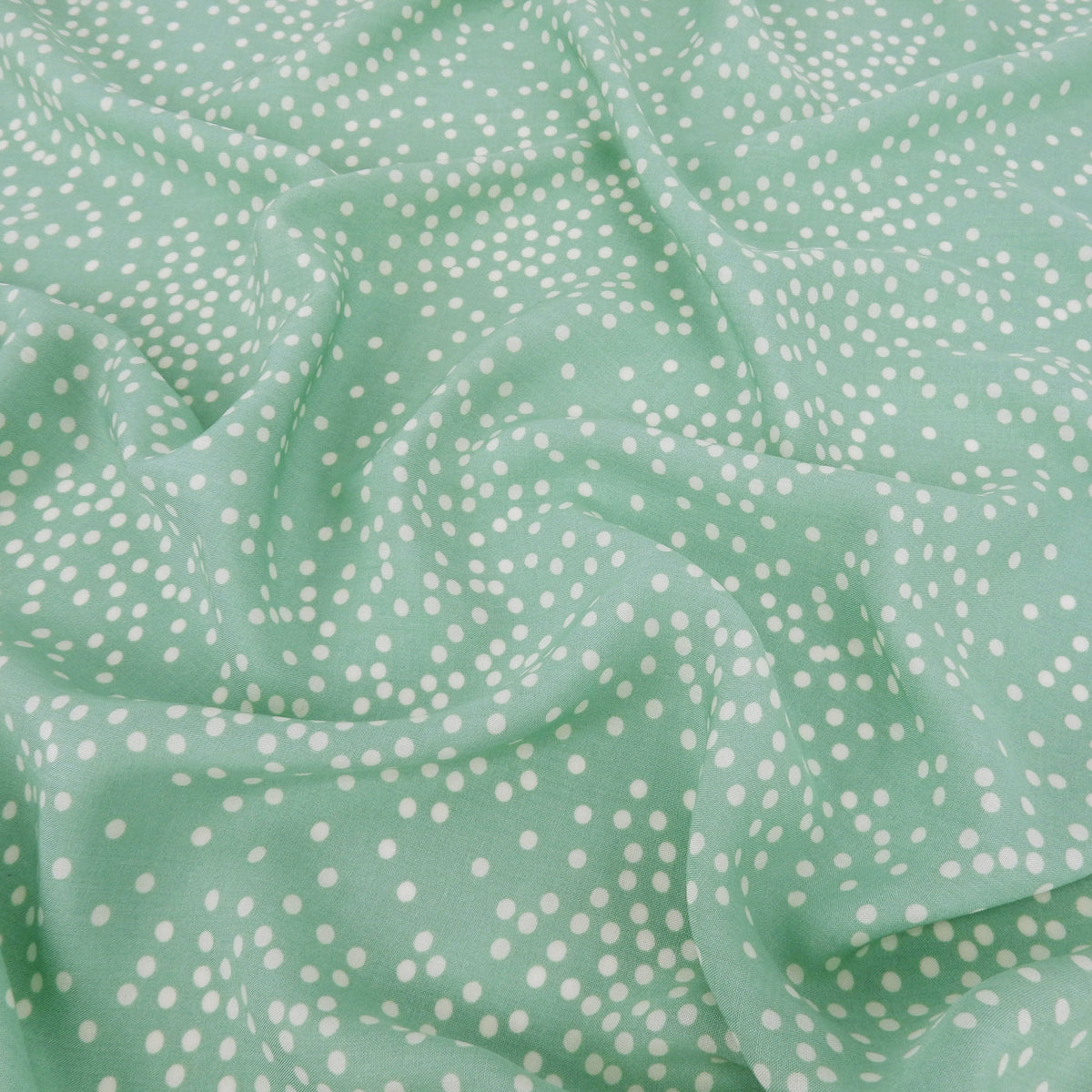 Premium 100% Rayon Challis Fabric. Artfully Spaced Polka Dot on Soft Mint. lightweight & ultra soft. shown lightly gathered