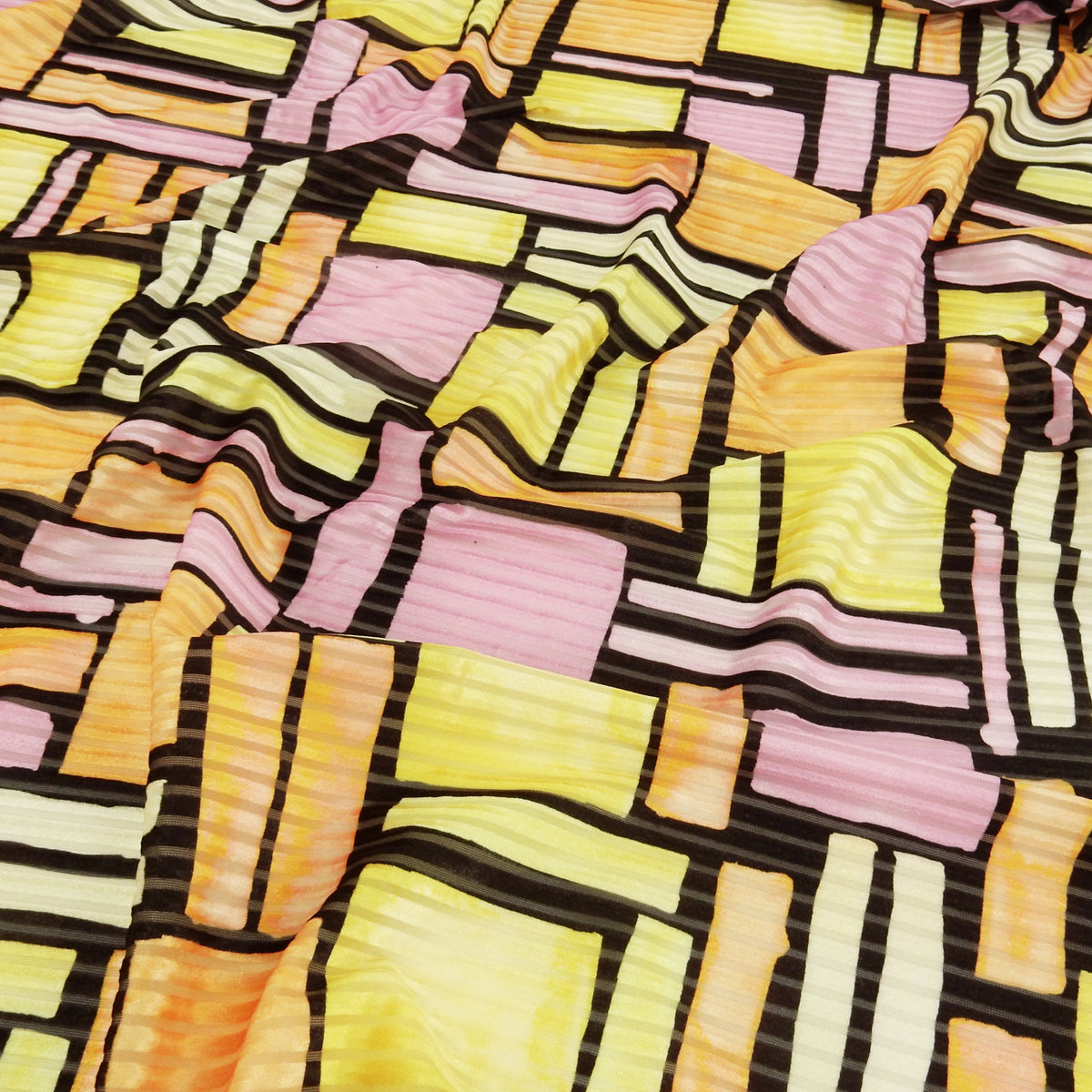 Premium Spanish Geometric Burnout Stretch Velvet fabric. Lemon Yellow, Soft Orange, Paris Pink, Ivory & Black. 4-way stretch. shown lightly gathered