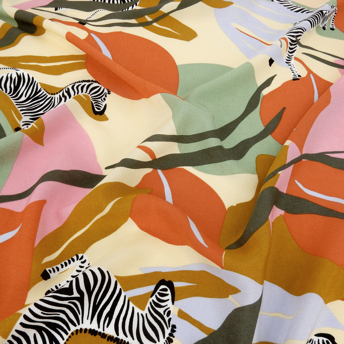 Premium 100% Rayon Challis Fabric. Artistic Zebra Safari Print in Terracotta, Sage & Soft Cream. lightweight & ultra soft. shown lightly gathered