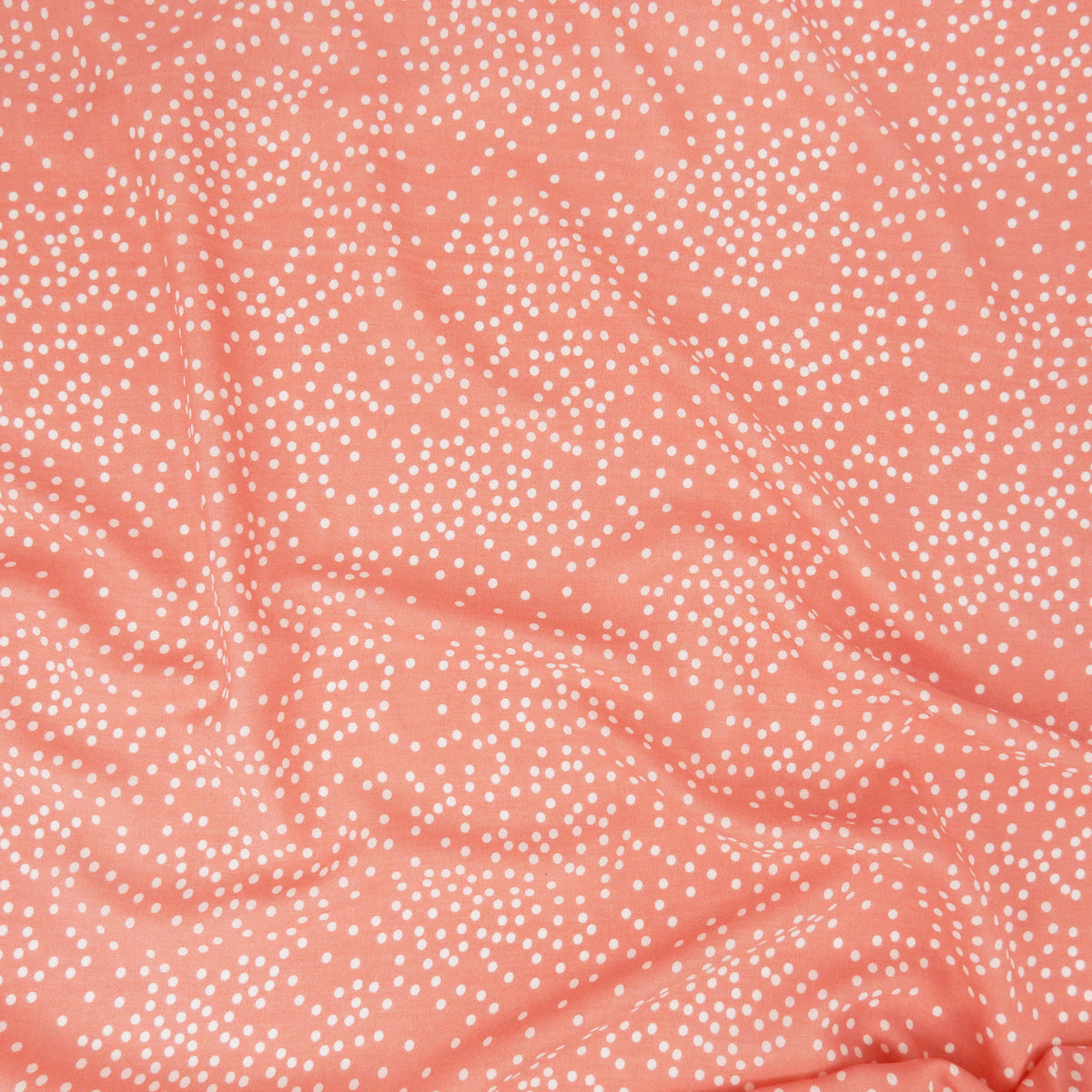 Premium 100% Rayon Challis Fabric. Artfully Spaced Polka Dot on Soft Coral. lightweight & ultra soft. shown lightly gathered