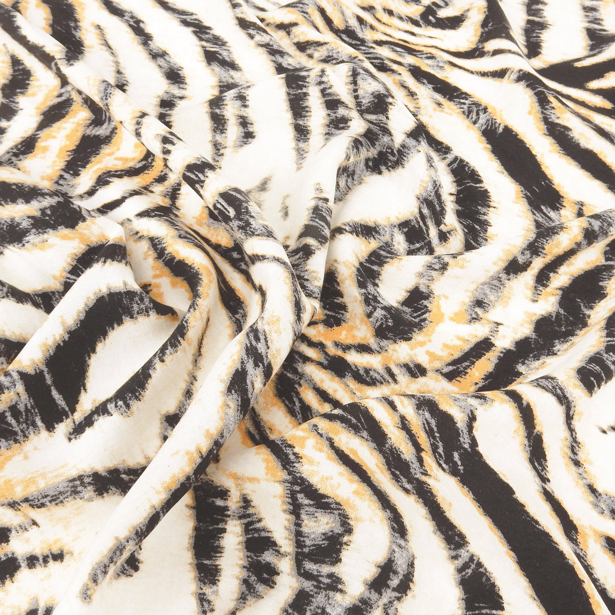 Premium 100% Rayon Challis Fabric. Artistic Tiger Stripe Print in Soft Orange, Charcoal & Creamy White. lightweight & ultra soft. shown lightly gathered