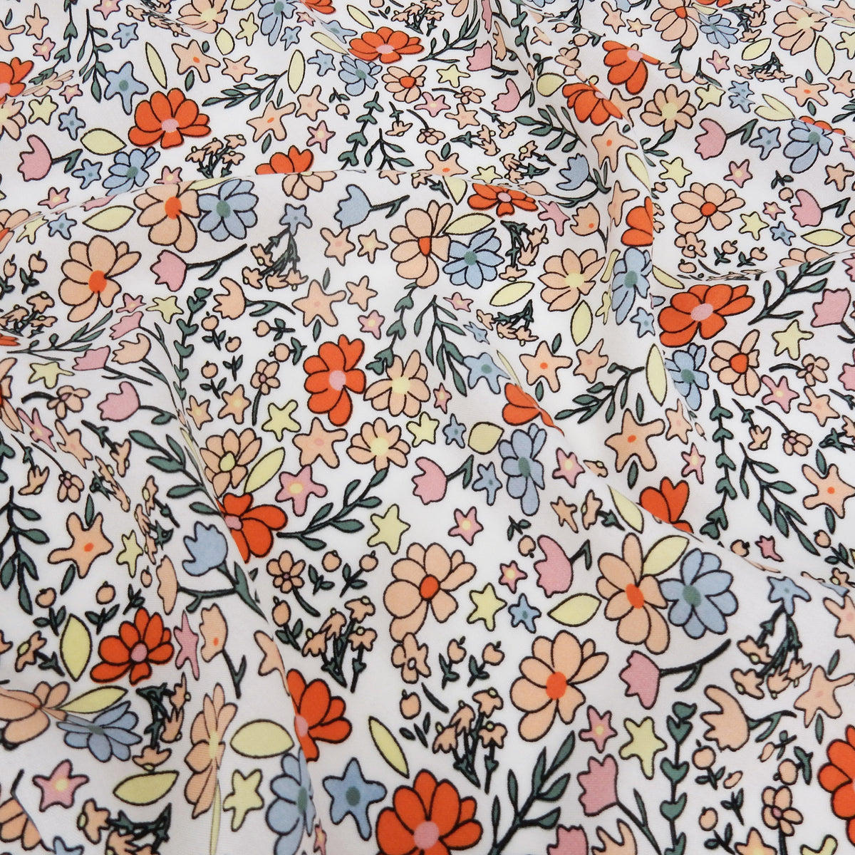 Premium 100% Rayon Challis Fabric. Playful Millefleurs Floral in Burnt Orange, Peach, Dusty Blue, Soft Yellow & Pink. lightweight & ultra soft. shown lightly gathered
