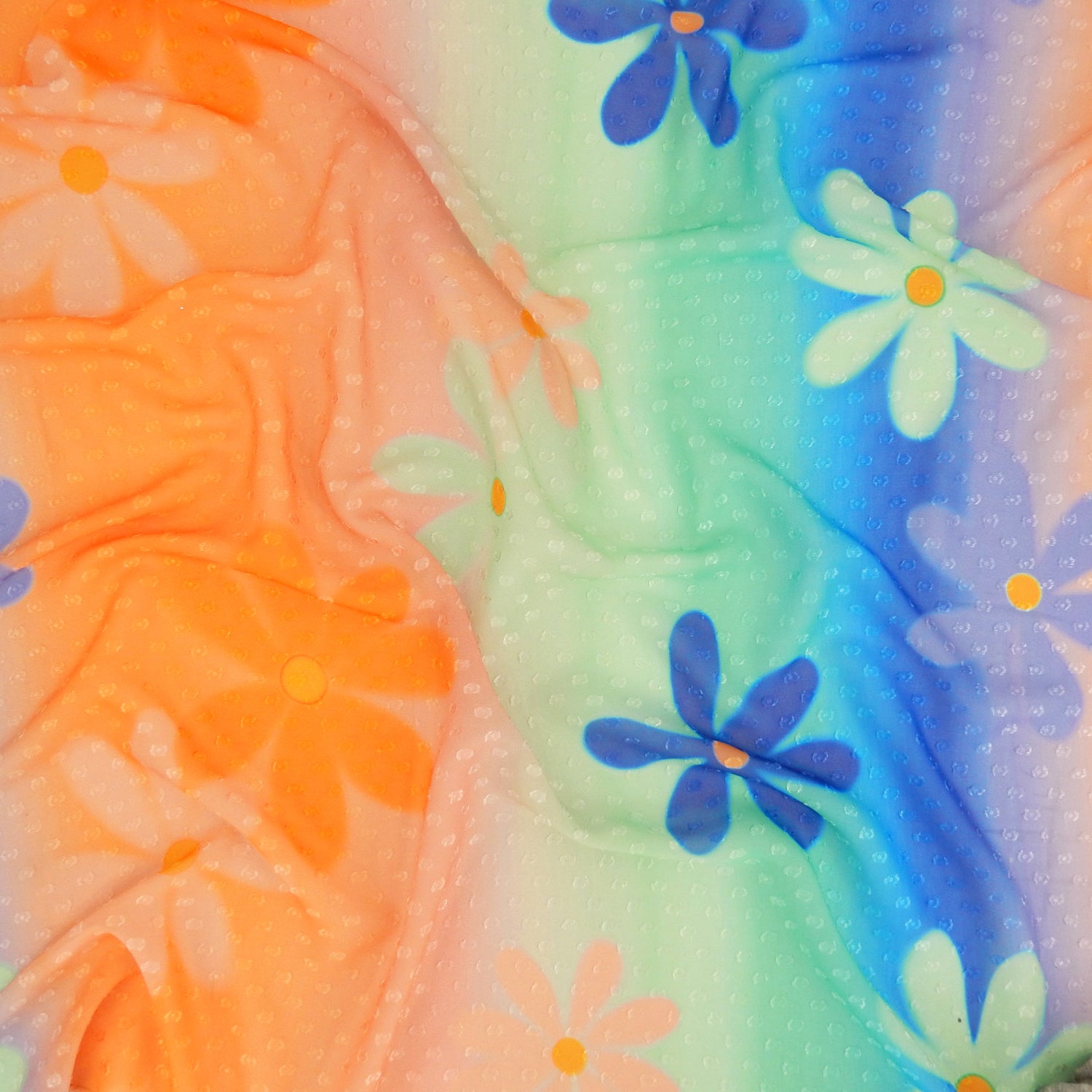 Premium floral printed clip dot fabric. semi sheer with raised clip dots. Modern flower design on multicolor railroad stripe. shown lightly gathered