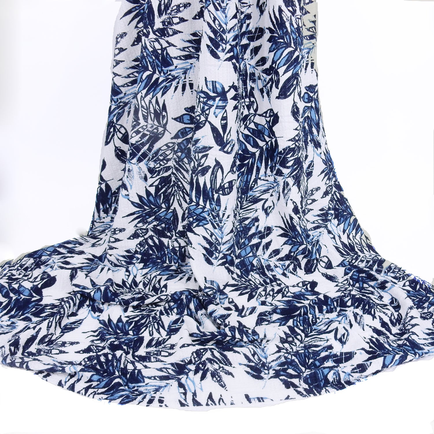 Premium  textured stretch jacquard apparel fabric. Luxury lightweight polyester spandex blend.  deep navy & breezy chambray blue tropical leaf design. shown draped