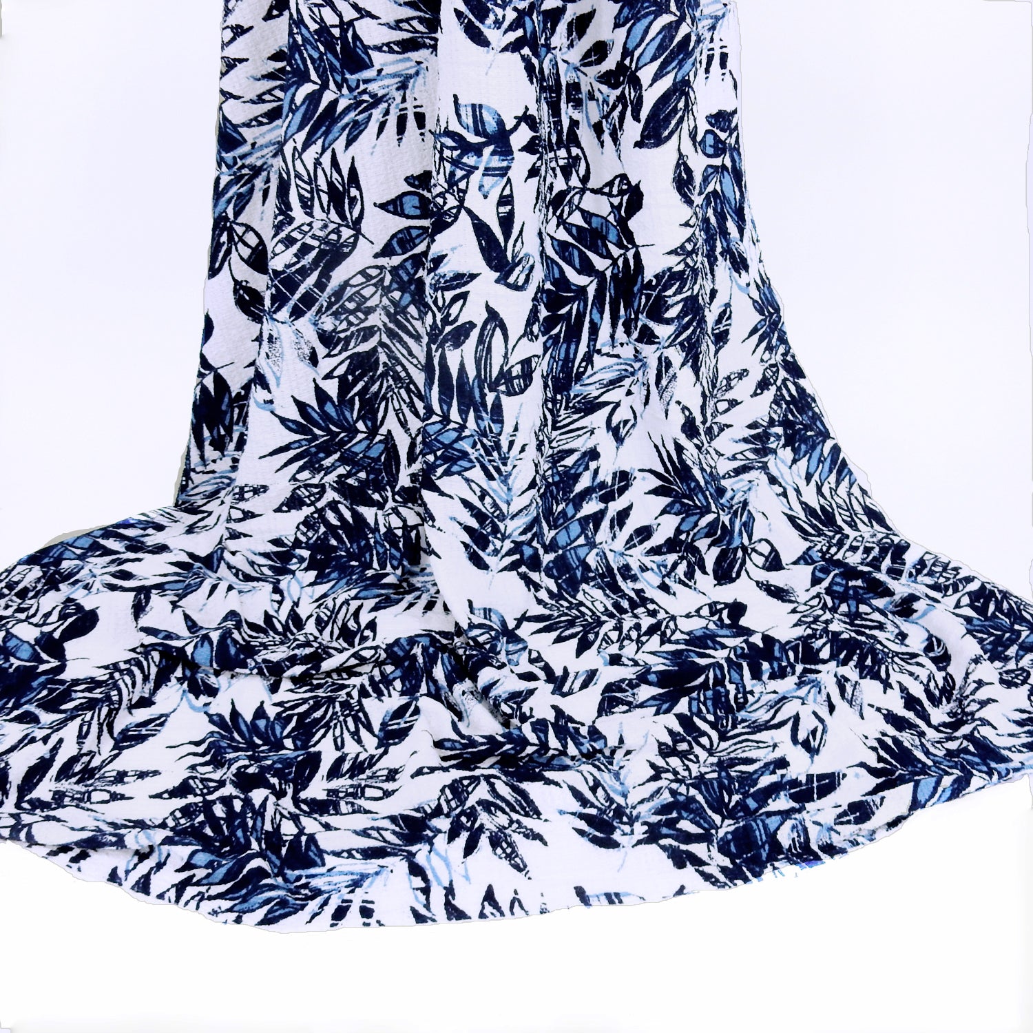 Premium  textured stretch jacquard apparel fabric. Luxury lightweight polyester spandex blend.  deep navy & breezy chambray blue tropical leaf design. shown draped