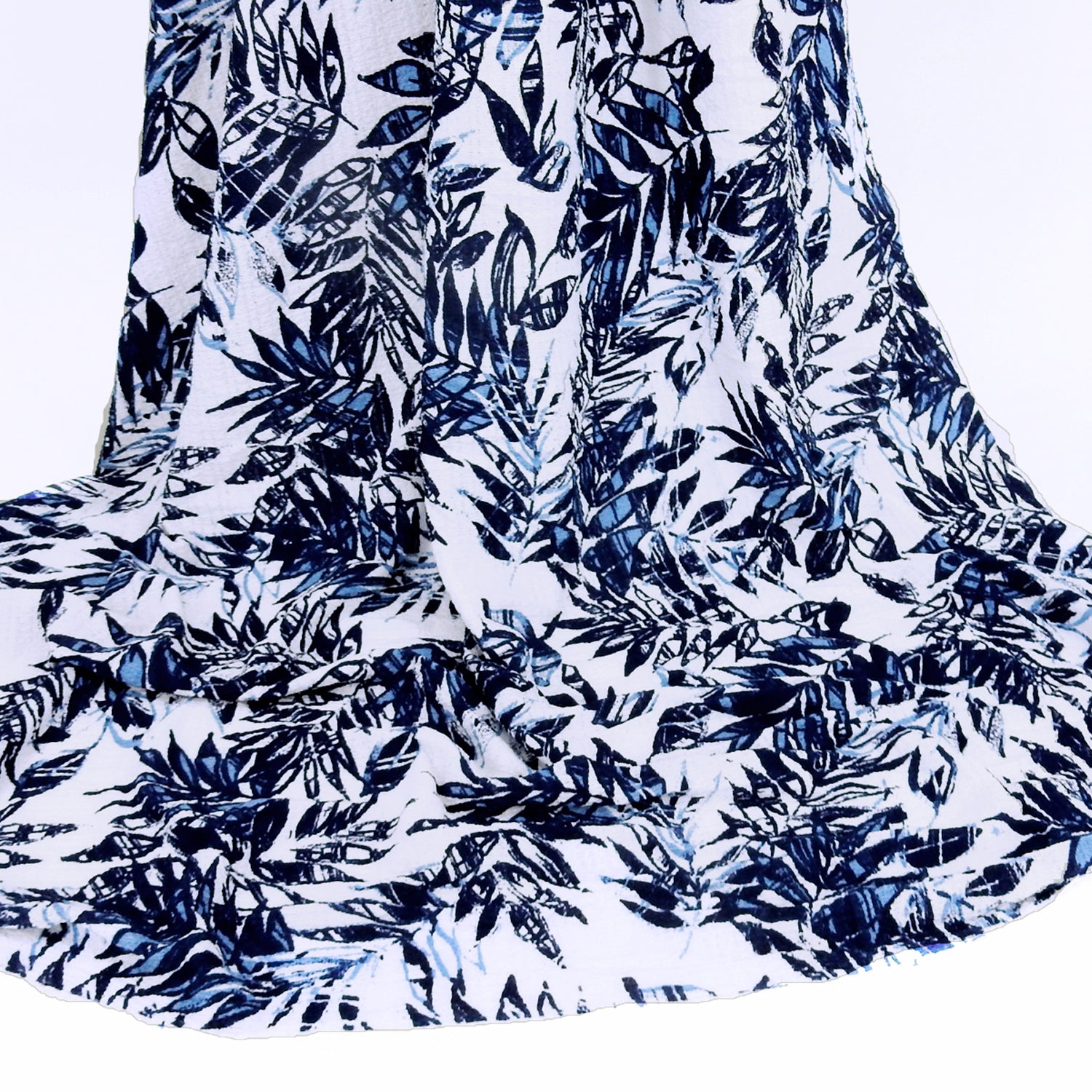 Premium  textured stretch jacquard apparel fabric. Luxury lightweight polyester spandex blend.  deep navy & breezy chambray blue tropical leaf design. shown draped
