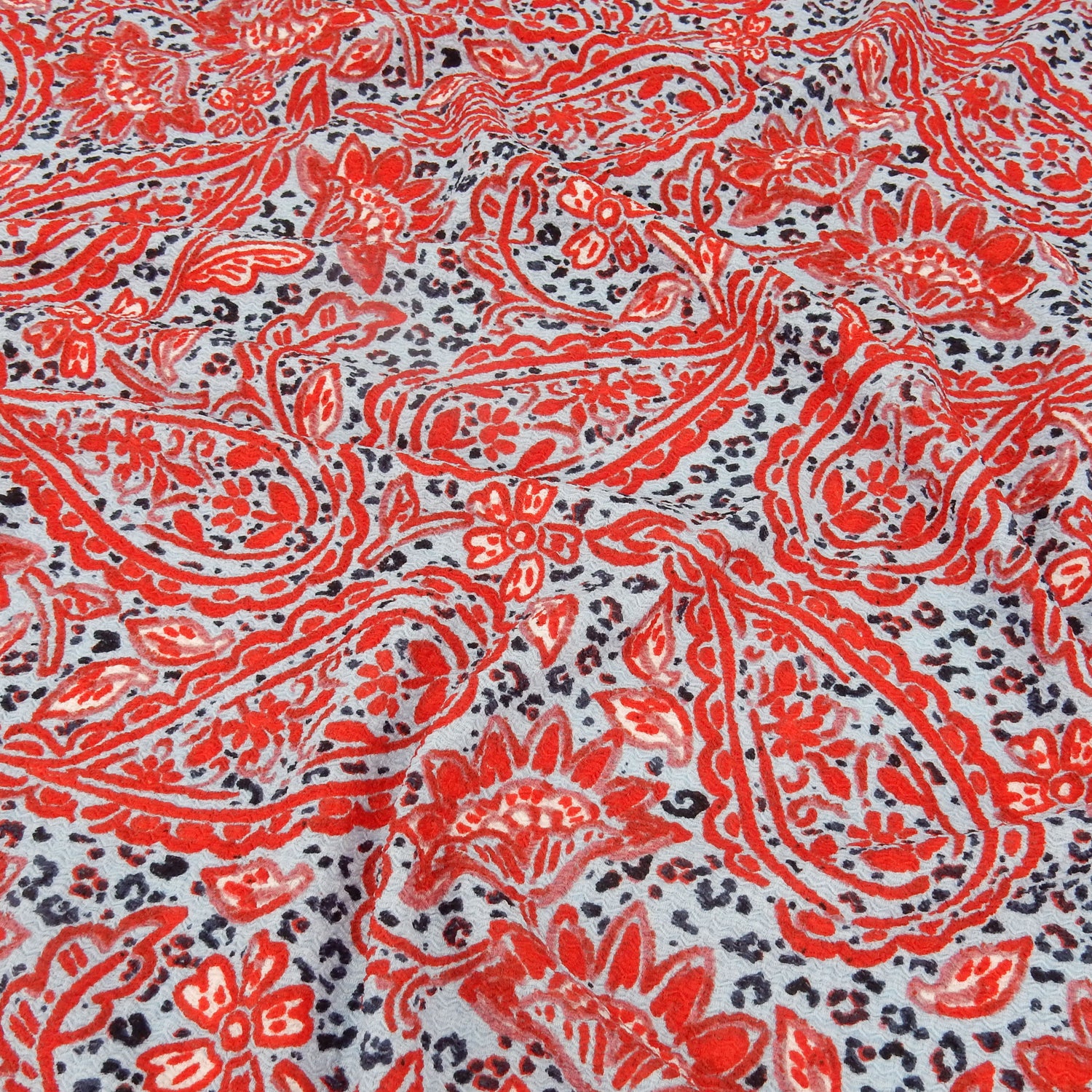 Premium  textured stretch jacquard dress fabric. Luxury lightweight polyester spandex blend. Red & sky blue paisley design. shown slightly gathered