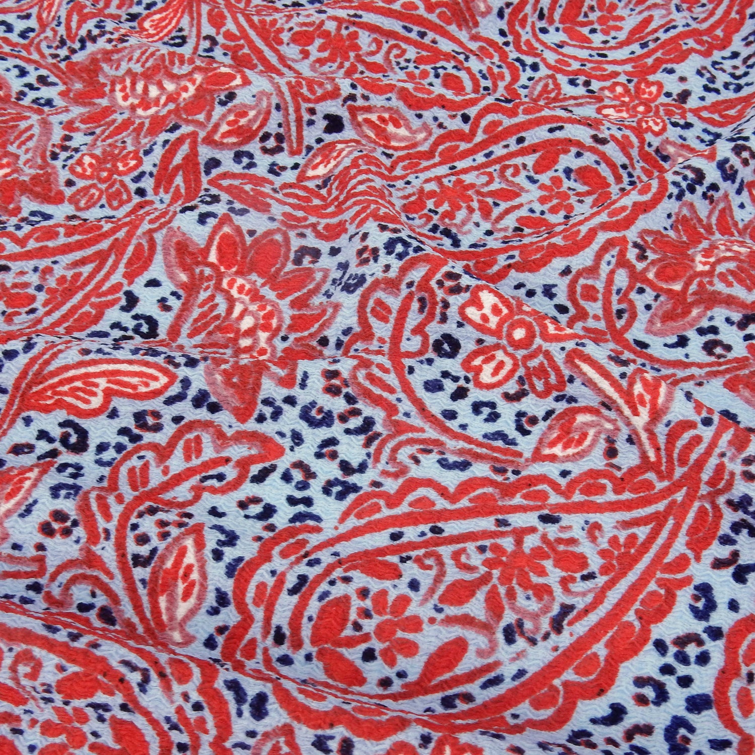 Premium  textured stretch jacquard dress fabric. Luxury lightweight polyester spandex blend. Red & sky blue paisley design. shown slightly gathered up