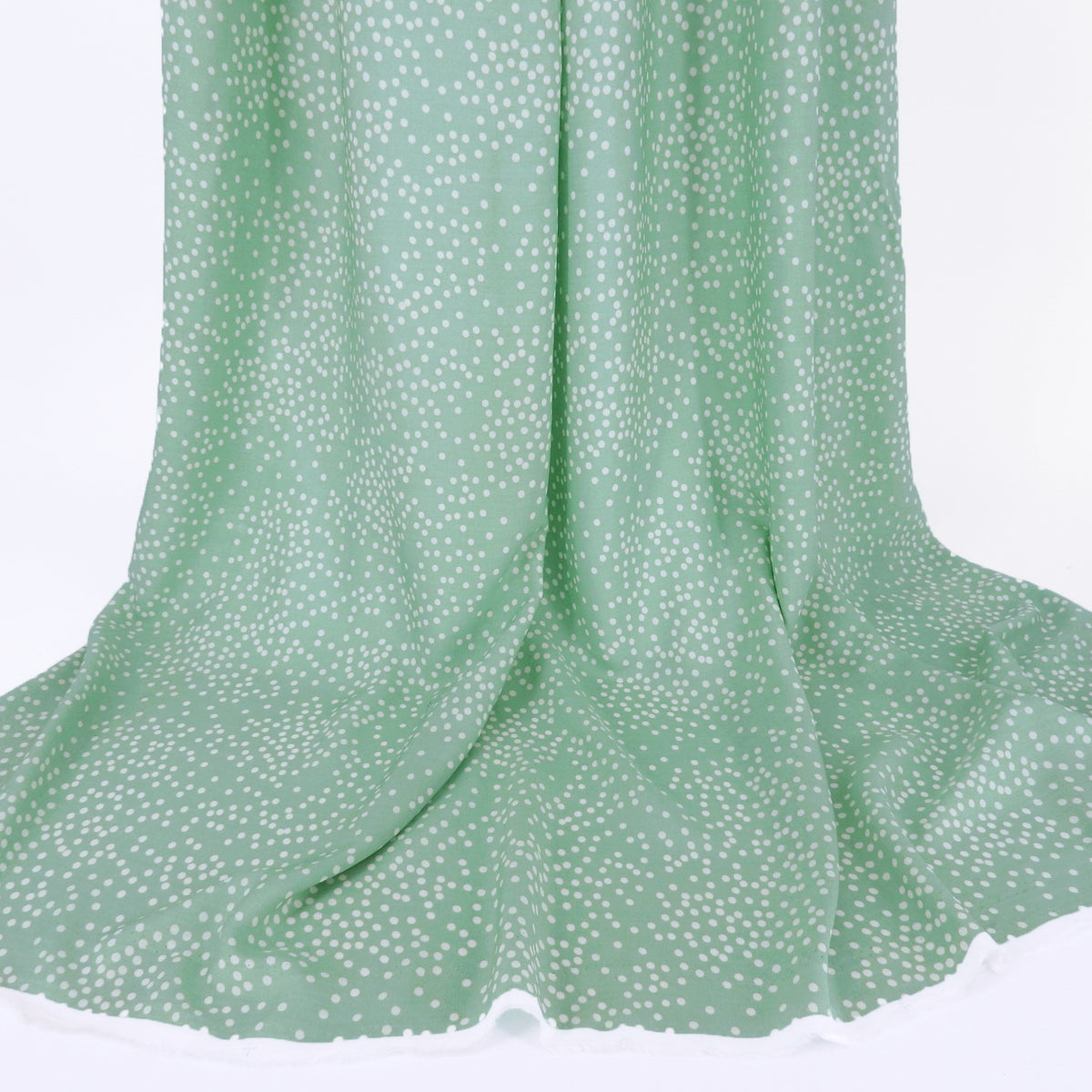 Premium 100% Rayon Challis Fabric. Artfully Spaced Polka Dot on Soft Mint. lightweight & ultra soft. shown draped