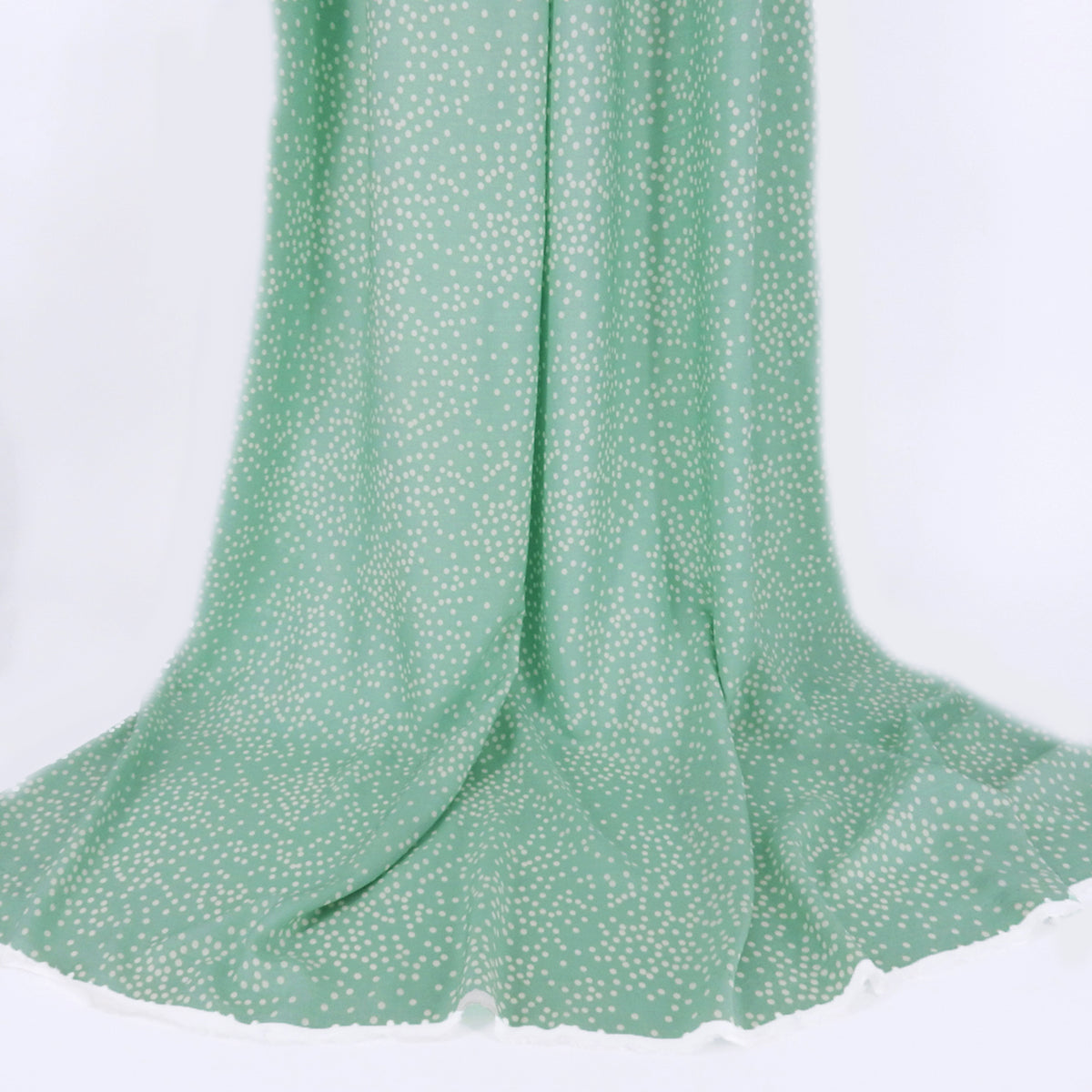 Premium 100% Rayon Challis Fabric. Artfully Spaced Polka Dot on Soft Mint. lightweight & ultra soft. shown draped