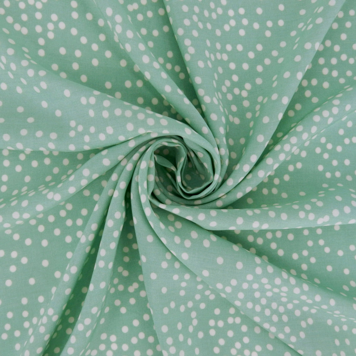 Premium 100% Rayon Challis Fabric. Artfully Spaced Polka Dot on Soft Mint. lightweight & ultra soft. shown swirled