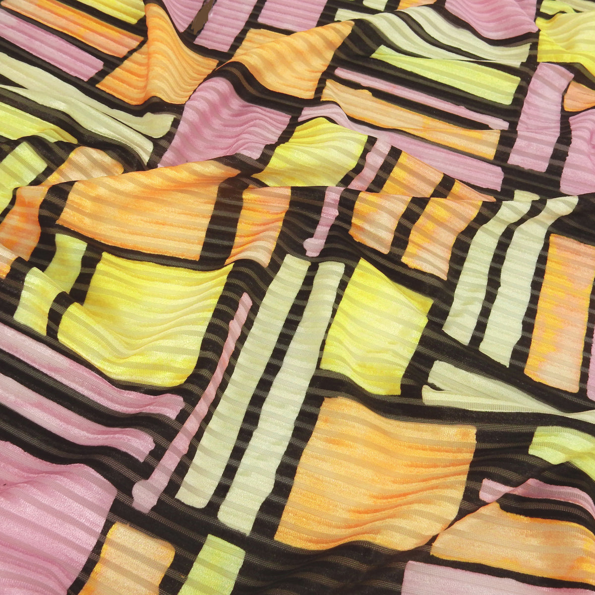 Premium Spanish Geometric Burnout Stretch Velvet fabric. Lemon Yellow, Soft Orange, Paris Pink, Ivory & Black. 4-way stretch. shown lightly gathered