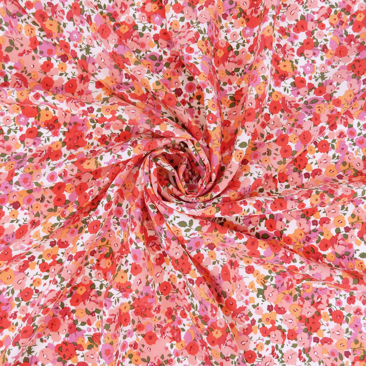 Premium 100% Rayon Challis Fabric. Radiant Millefleurs Floral in Coral, Fuchsia, Red & Peach. lightweight & ultra soft. shown swirled