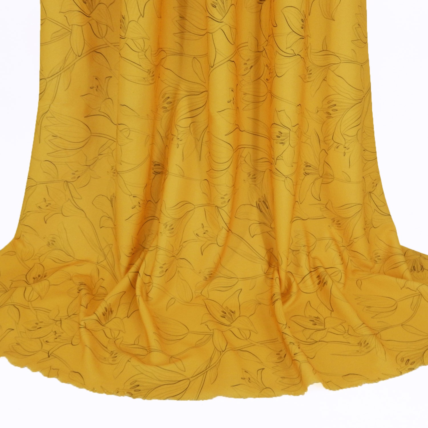 Premium Pebble Crepe Double Stretch Knit Fabric.  Lily floral design on rich gold 2-way stretch polyester crepe. shown draped