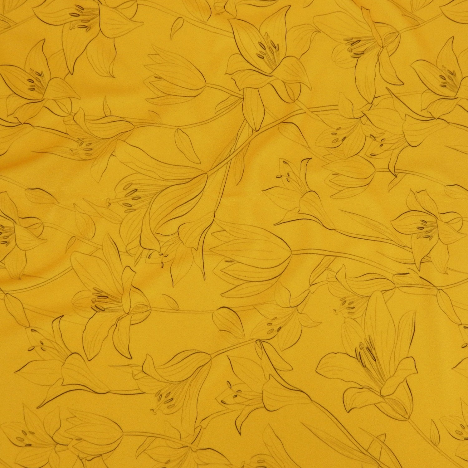 Premium Pebble Crepe Double Stretch Knit Fabric.  Lily floral design on rich gold 2-way stretch polyester crepe. shown flat
