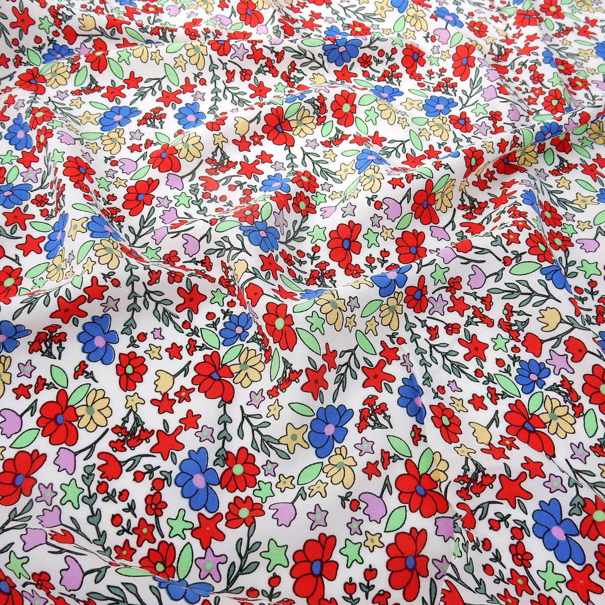 Premium 100% Rayon Challis Fabric. Playful Millefleurs Floral in Red, Periwinkle, Soft Yellow, Lilac & Mint. lightweight & ultra soft. shown lightly gathered
