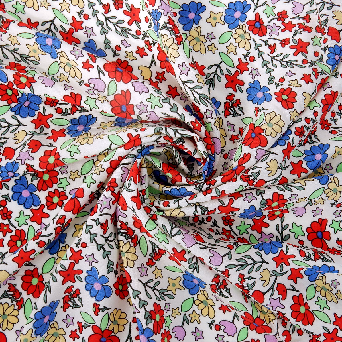 Premium 100% Rayon Challis Fabric. Playful Millefleurs Floral in Red, Periwinkle, Soft Yellow, Lilac & Mint. lightweight & ultra soft. shown swirled