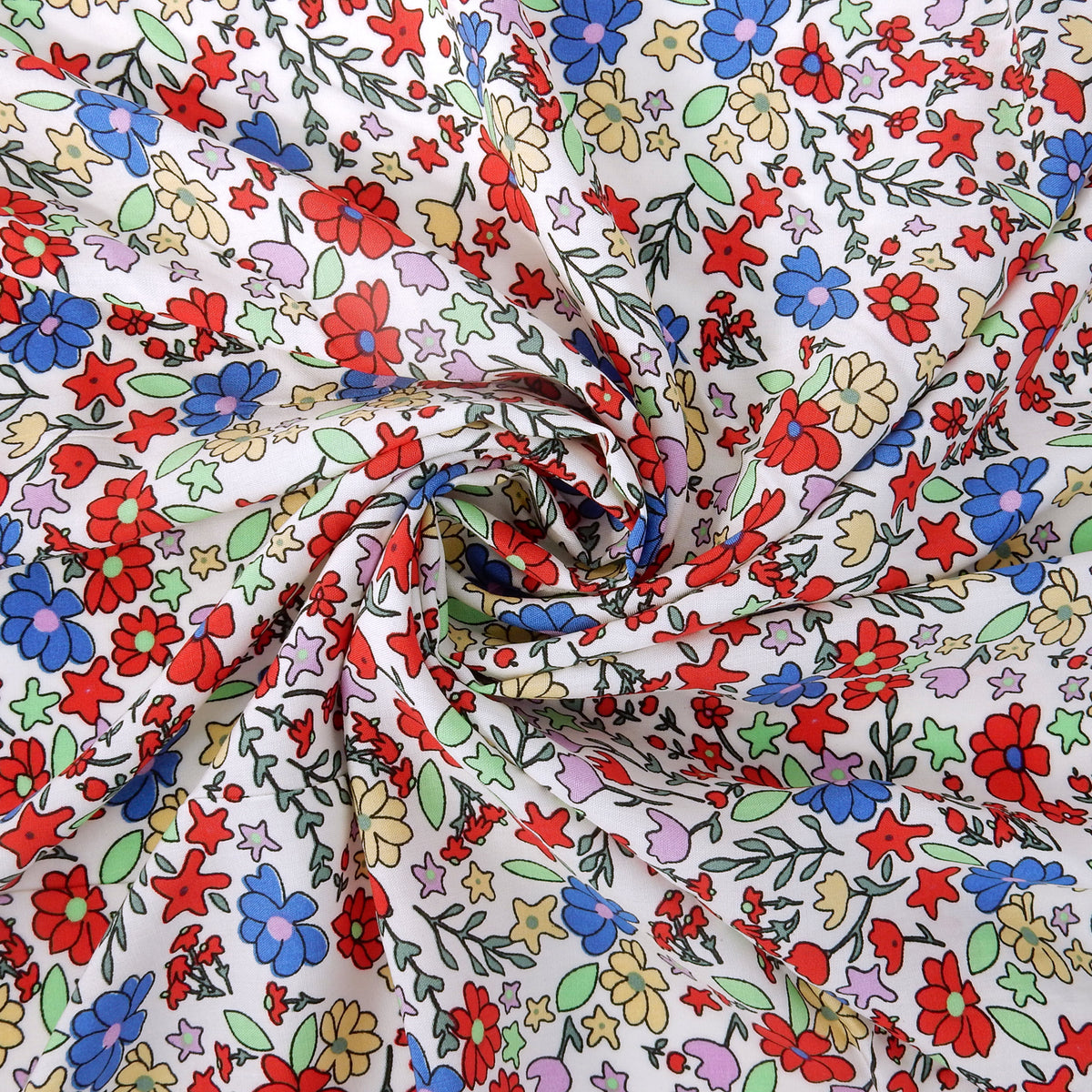 Premium 100% Rayon Challis Fabric. Playful Millefleurs Floral in Red, Periwinkle, Soft Yellow, Lilac & Mint. lightweight & ultra soft. shown swirled