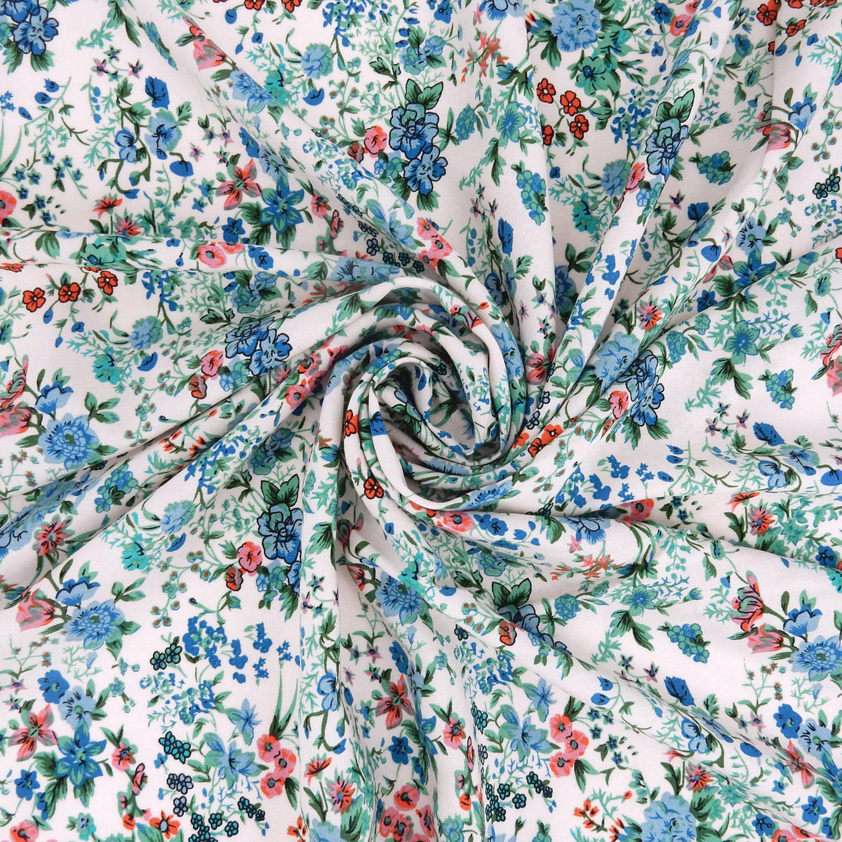 Premium 100% Rayon Challis Fabric. Playful Millefleurs Floral in Sky Blue, Terracotta, Royal Blue on Cream lightweight & ultra soft. shown swirled