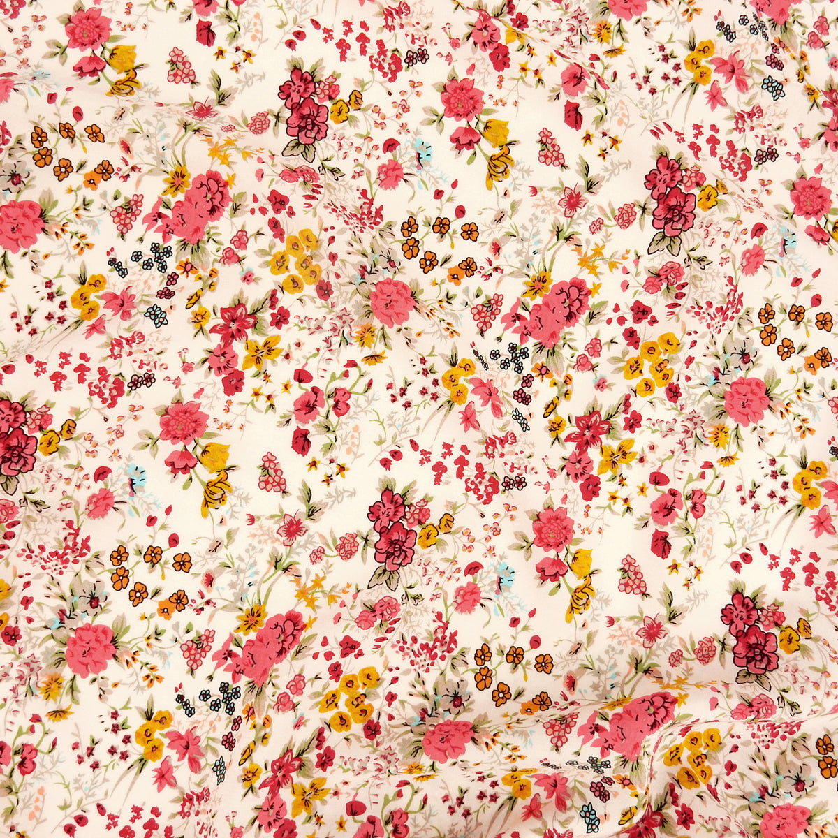 Premium 100% Rayon Challis Fabric. Playful Millefleurs Floral in Red Rose, Gold & Sky Blue on Pale Pink background. lightweight & ultra soft. shown flat