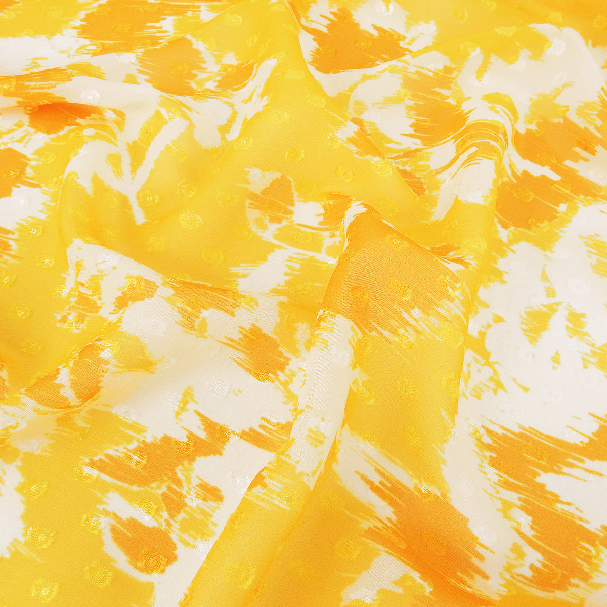 Premium 100% Rayon Challis Fabric. Printed clip dot watercolor in golden yellow, orange & soft cream. Semi-sheer with raised clip dots. shown lightly gathered