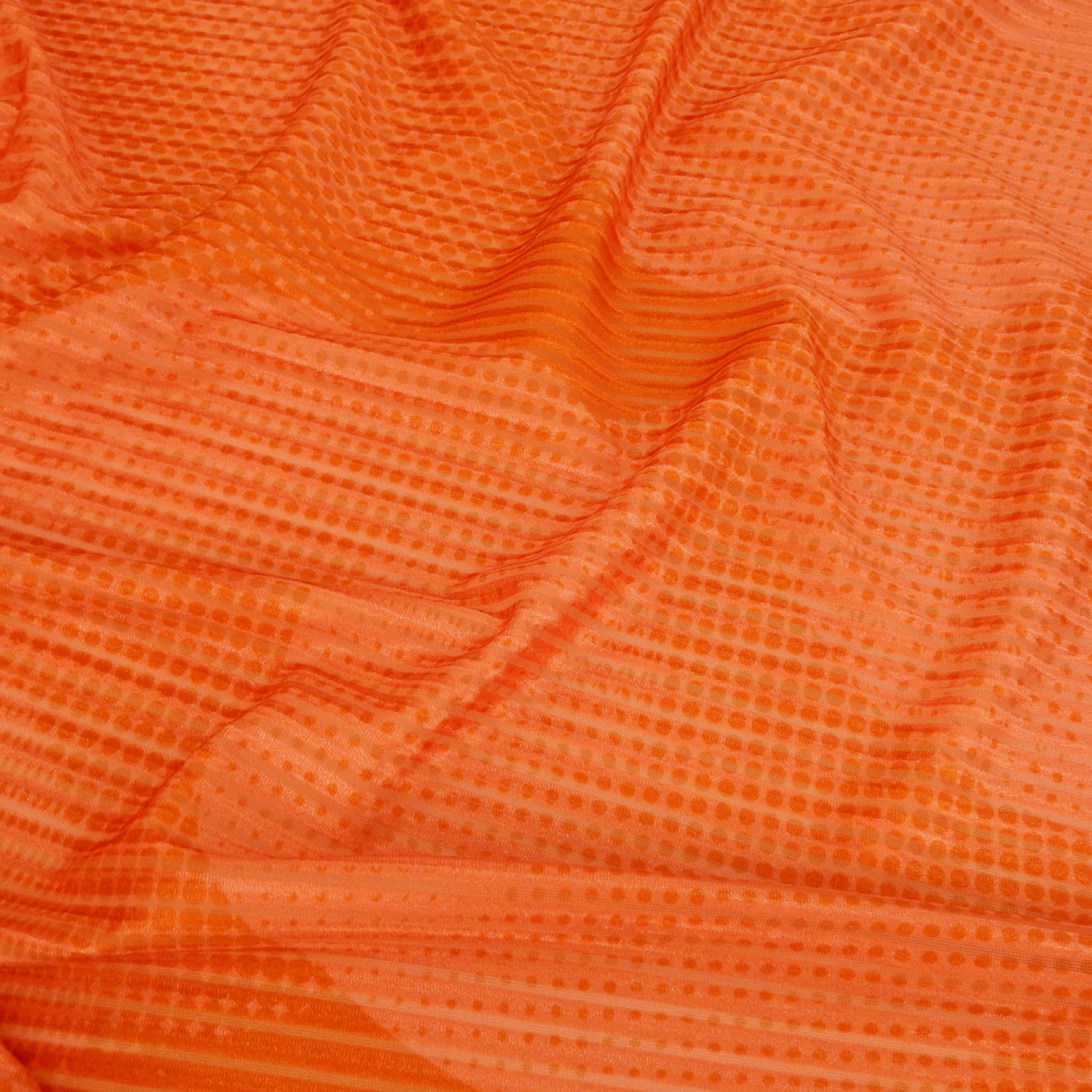 Premium Printed Burnout Stretch Velvet Fabric. Luxury spanish ombre' spice & orange design on polyester spandex horizontal stripe velvet burnout. Shown lightly gathered